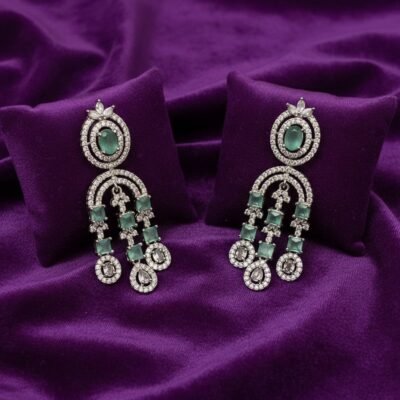 04 womlysh american diamond and faux emerald dangler mint green and silver earrings top down view 829