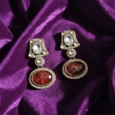 04 womlysh gold toned metal and gleaming crystals drop earrings maroon and gold earrings top down view 799