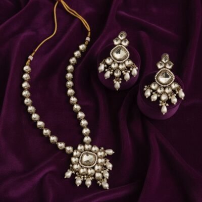 04 womlysh kundan gold toned metal traditional statement set gold and white necklace set top down view 1049